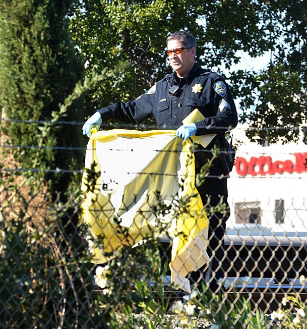 The Associated Press A BART police officer covers one of the two people that were struck and killed by a moving BART train along Jones Road in Walnut Creek, Calif., on Saturday, Oct. 19, 2013. (AP Photo/The Mercury News, Dan Rosenstrauch